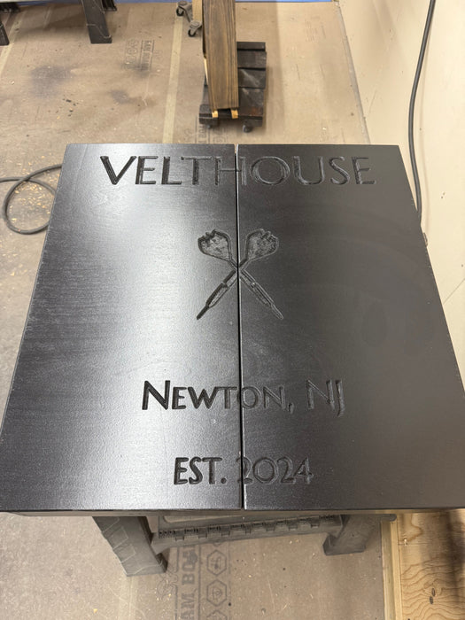 Metal plaque with 'Velthouse' and 'Newton, NJ EST. 2024' engraved on a concrete floor.