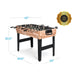 Foosball table with dimensions and safety certification label on a white background