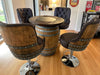 Wooden barrel table with four bar stools in a room setting.