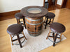 Wooden barrel table with four bar stools in a room setting.
