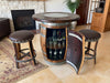 Wine barrel bar with glass shelves, stools, and a fireplace in the background.