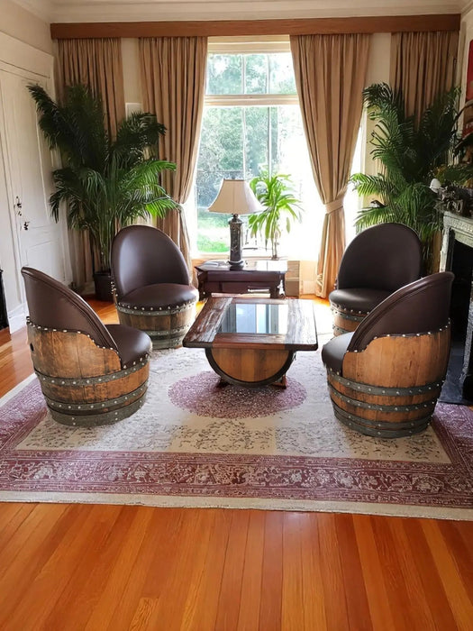 Living room with barrel chairs and a table in front of a large window.