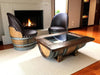 Wooden barrel chairs and table in a living room setting with a fireplace.