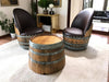 Two barrel chairs with a matching table in a living room setting.