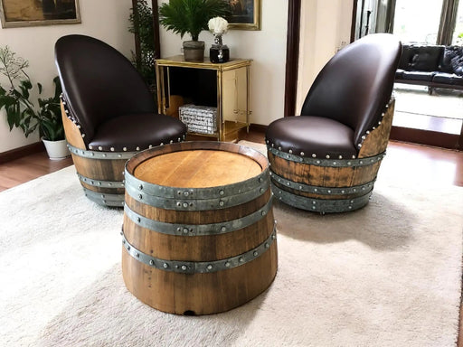 Two barrel chairs with a matching table in a living room setting.
