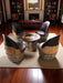 Wine barrel chairs and table in a living room setting with a fireplace.