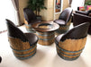 Wooden barrel chairs with a central table in a room setting.