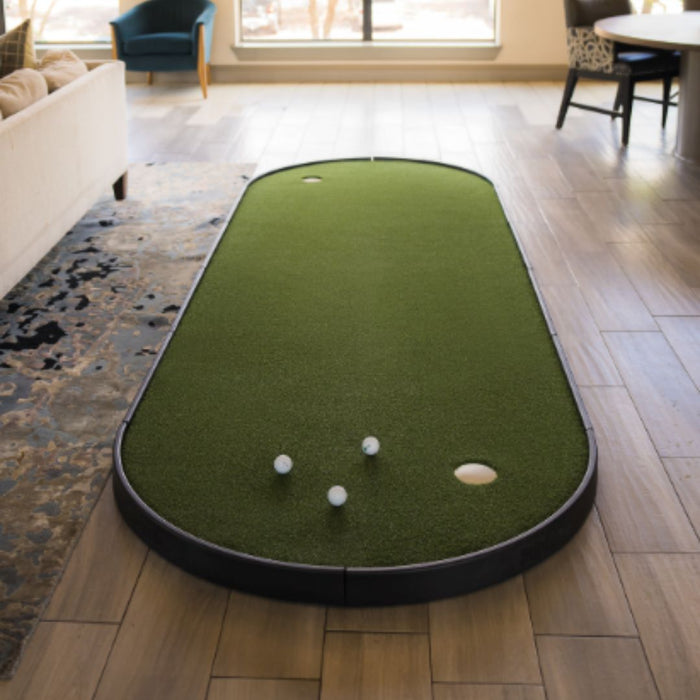 Miniature golf putting green setup on a wooden floor in a living room.