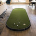 Miniature golf putting green setup on a wooden floor in a living room.