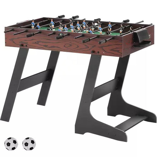 Foosball table with two additional balls on a white background