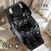 Black massage chair with musical notes and control icons in a bright room.