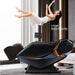 Zero gravity massage chair with a woman relaxing on it in a modern living room.