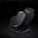 Black massage chair on a dark background