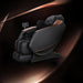 Black massage chair with brown accents on a dark background