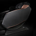 Black massage chair with rose gold accents on a black background