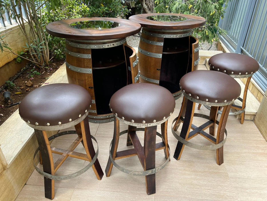 Bar set made from wine barrels with stools on a wooden deck.
