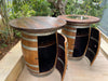 Two wooden barrel tables with metal accents on a wooden deck.