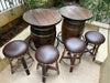 Wooden barrel table with matching stools on a patio