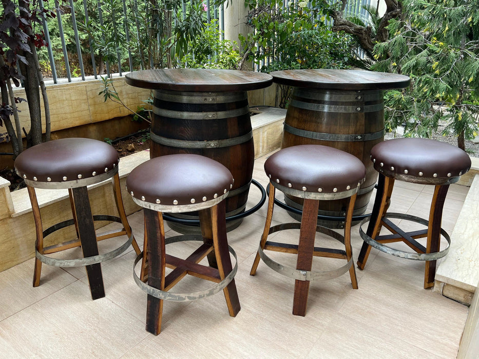 Bar stools made from repurposed wine barrels with leather seats in an outdoor setting.