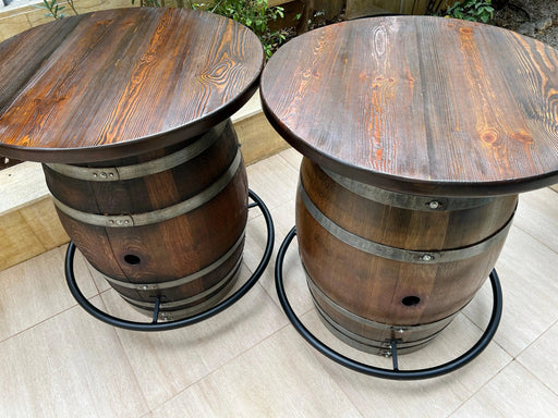 Two wooden barrel tables on a tiled floor.