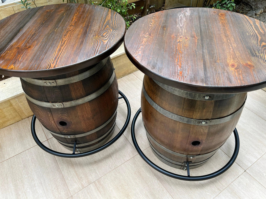 Two wooden barrel tables on a tiled floor.