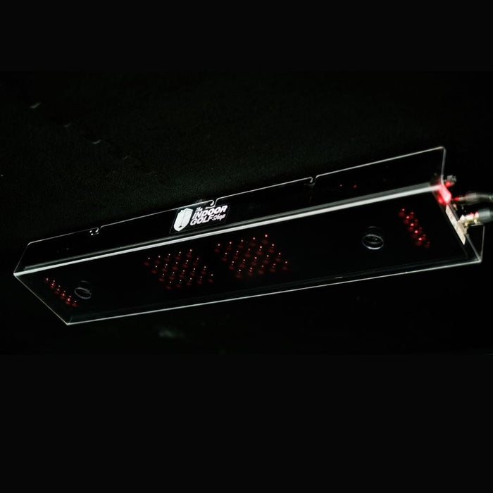 Clear electronic device with red lights on a black background