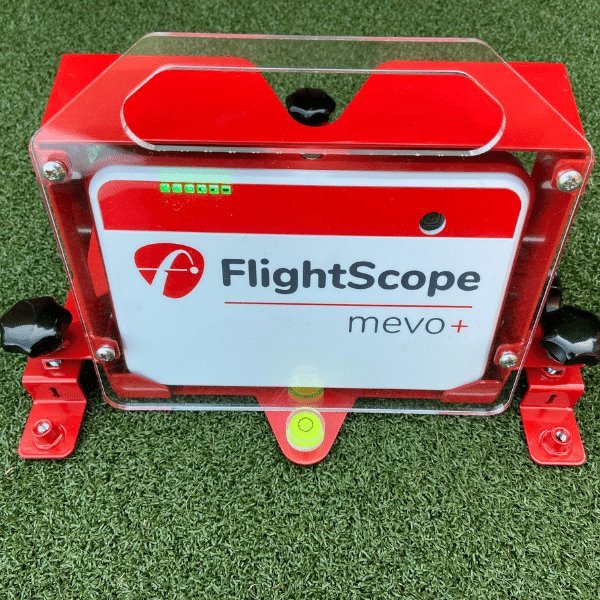 FlightScope mevo+ device on a green grass background