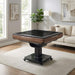 Black and wood grain gaming table in a living room setting with a couch and lamp.