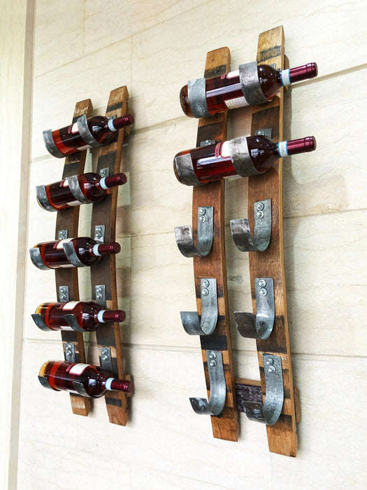 Wooden wine rack with bottles on a white wall