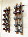 Wooden wine rack with bottles on a white wall