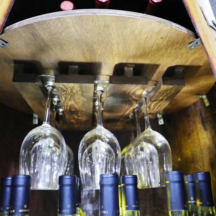 Wine bottles with blue labels and wine glasses hanging from a wooden shelf.