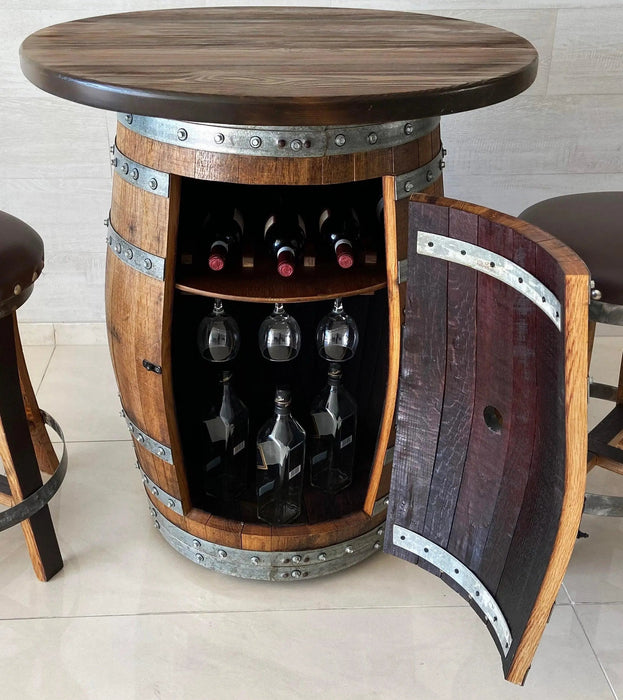 Wooden barrel-style bar table with wine bottles and glasses inside, on a tiled floor.