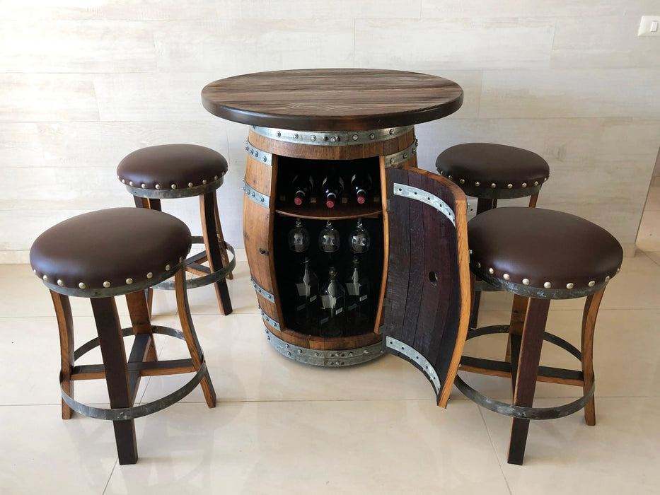 Wooden barrel table with wine bottles and four bar stools in a room.
