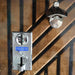 Metallic lock mechanism on a wooden door with a black metal handle.