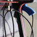Close-up of a bicycle wheel with a blue hub and black cables.