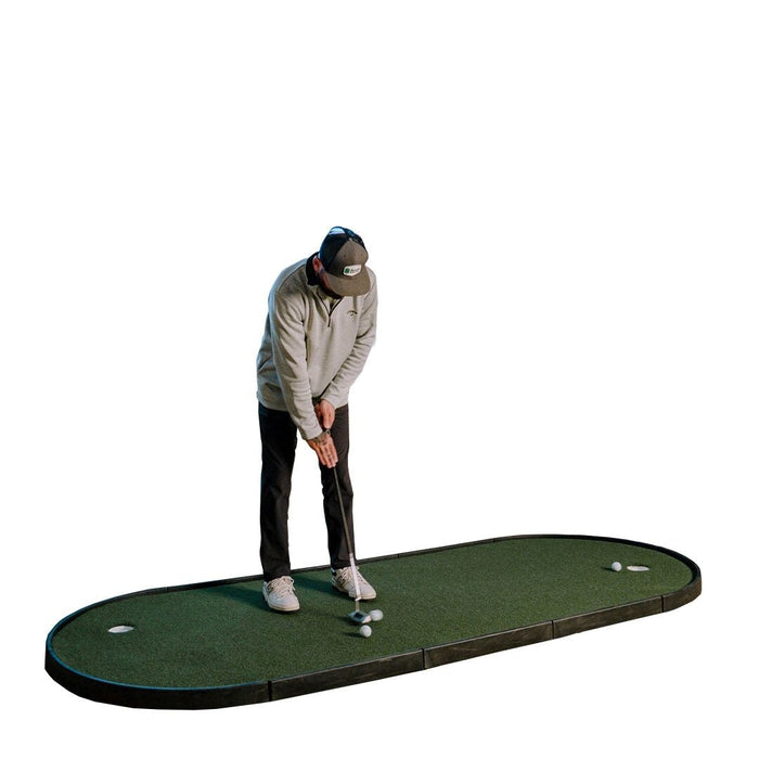 Person practicing golf on a green mat with white balls on a white background