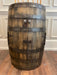 Wooden barrel with metal bands on a wooden floor