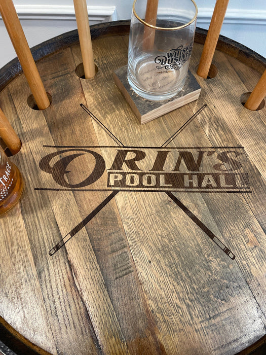 Wooden coaster with 'Orin's Pool Hall' branding on a wooden surface.