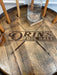 Wooden coaster with 'Orin's Pool Hall' branding on a wooden surface.