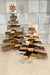Wooden Christmas tree with star toppers on a tiled floor