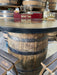 Wooden barrel table with Buffalo Trace bourbon branding and decor.