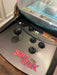 Close-up of an arcade machine with 'Bomb Jack' branding on a wooden floor.