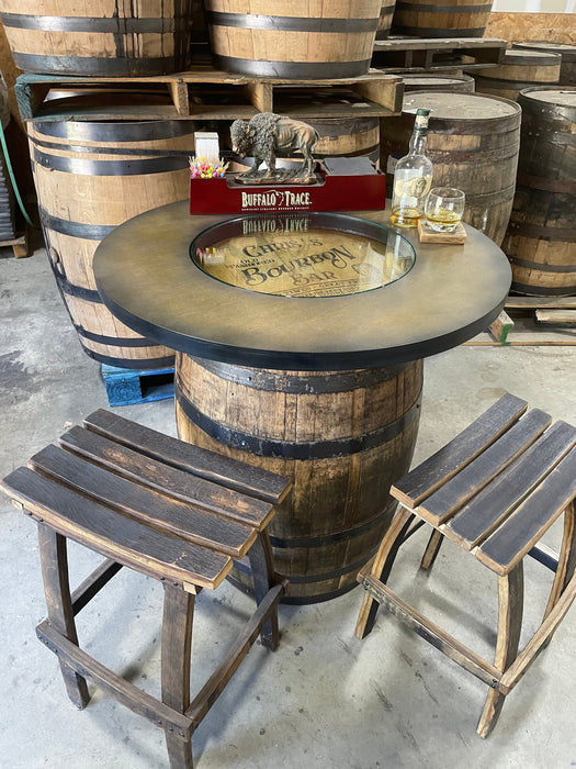Wooden barrel table with stools and decorative items in a warehouse setting
