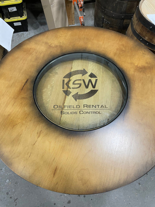 Wooden barrel with KSW Oilfield Rental Solids Control logo on a concrete floor.