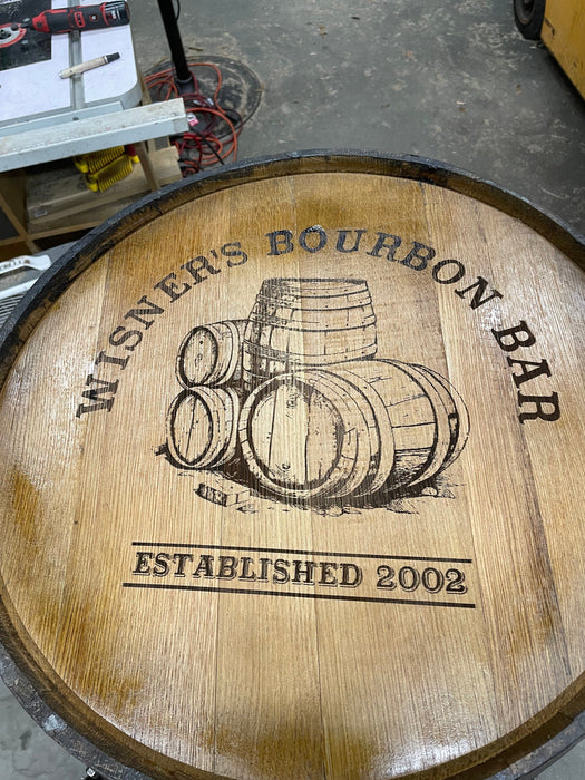 Wooden barrel with 'Winer's Bourbon Bar' engraving and illustration of barrels.