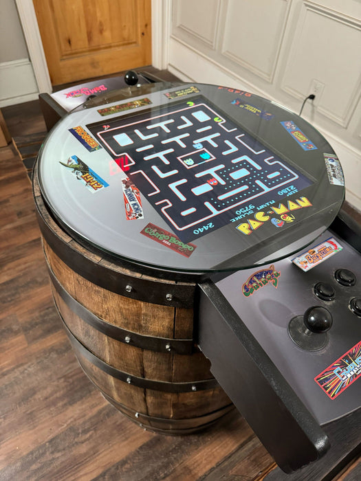 Arcade game console mounted on a wooden barrel
