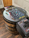 Arcade game console mounted on a wooden barrel