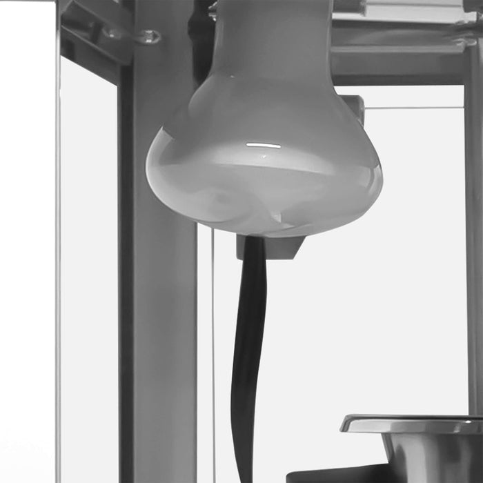 Close-up of a popcorn machine with a focus on the heat lamp bulb.