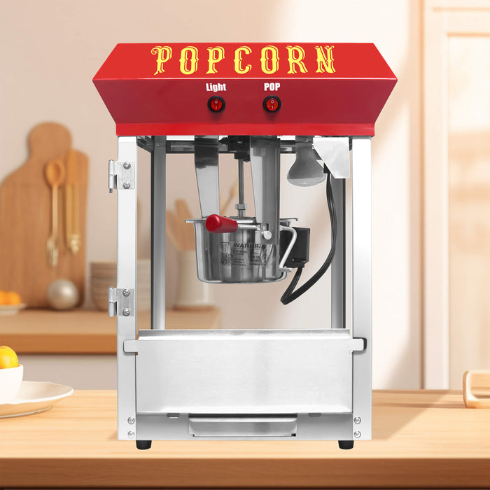 Popcorn machine with red top and 'POPCORN' text on a kitchen counter.