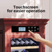 Wine cooler with touchscreen control panel and hand interacting with it.